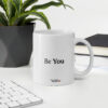 white glossy mug 11oz office environment 63b5bdd065cf3 This ceramic mug is the perfect blend of function and elegance. Ideal as a gift or an everyday essential for your dreamy cup of tea.